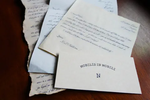 A pile of four letters, the front one reads &lsquo;Mobilis In Mobile - N&rsquo;